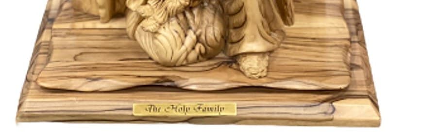 Close-up of the olive wood base of The Holy Family, Grand Tableau, showing dark streaks in the grain