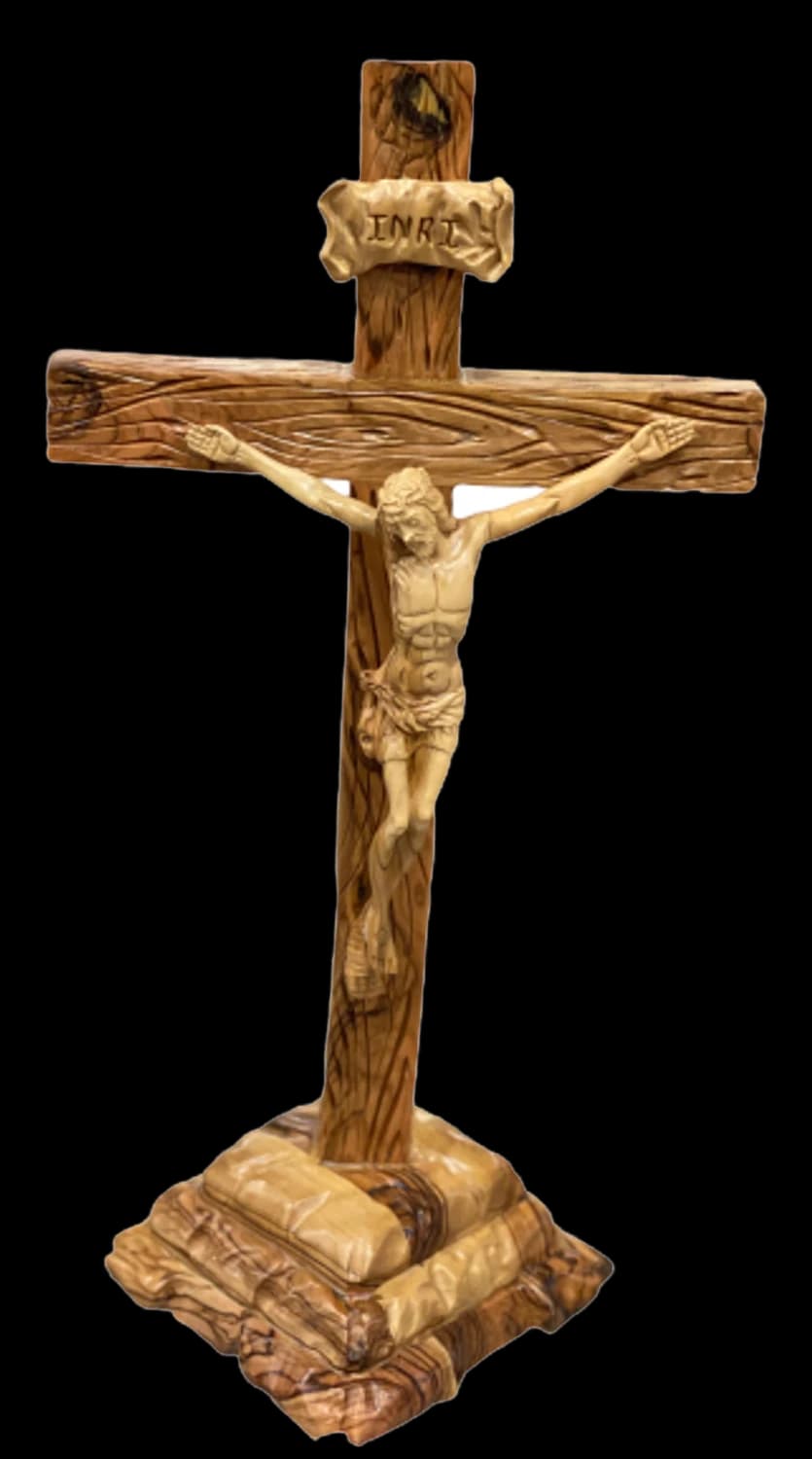 Olive wood crucifix standing on a carved rocky pedestal