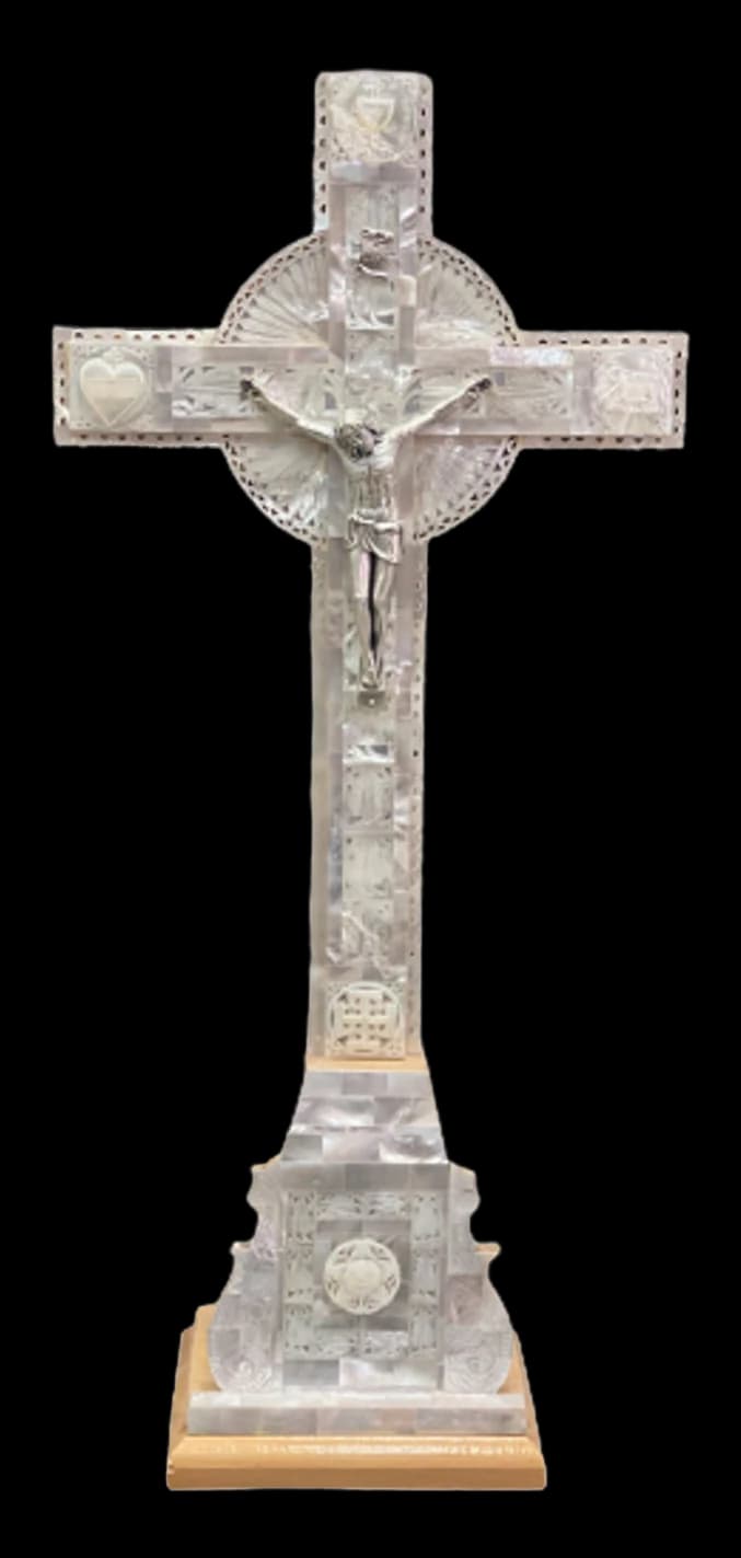 Mother of pearl crucifix standing on a stepped pedestal base